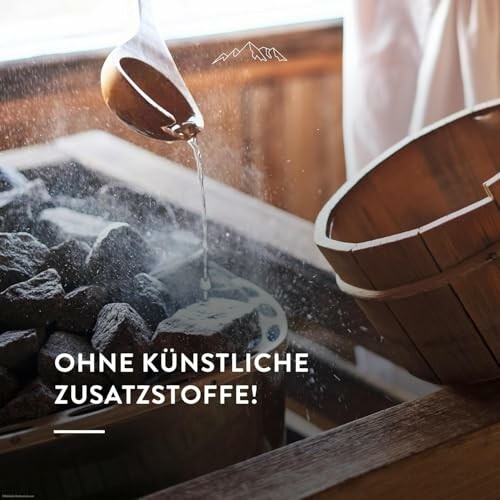 Wasser wird über Sauna-Steine gegossen.
